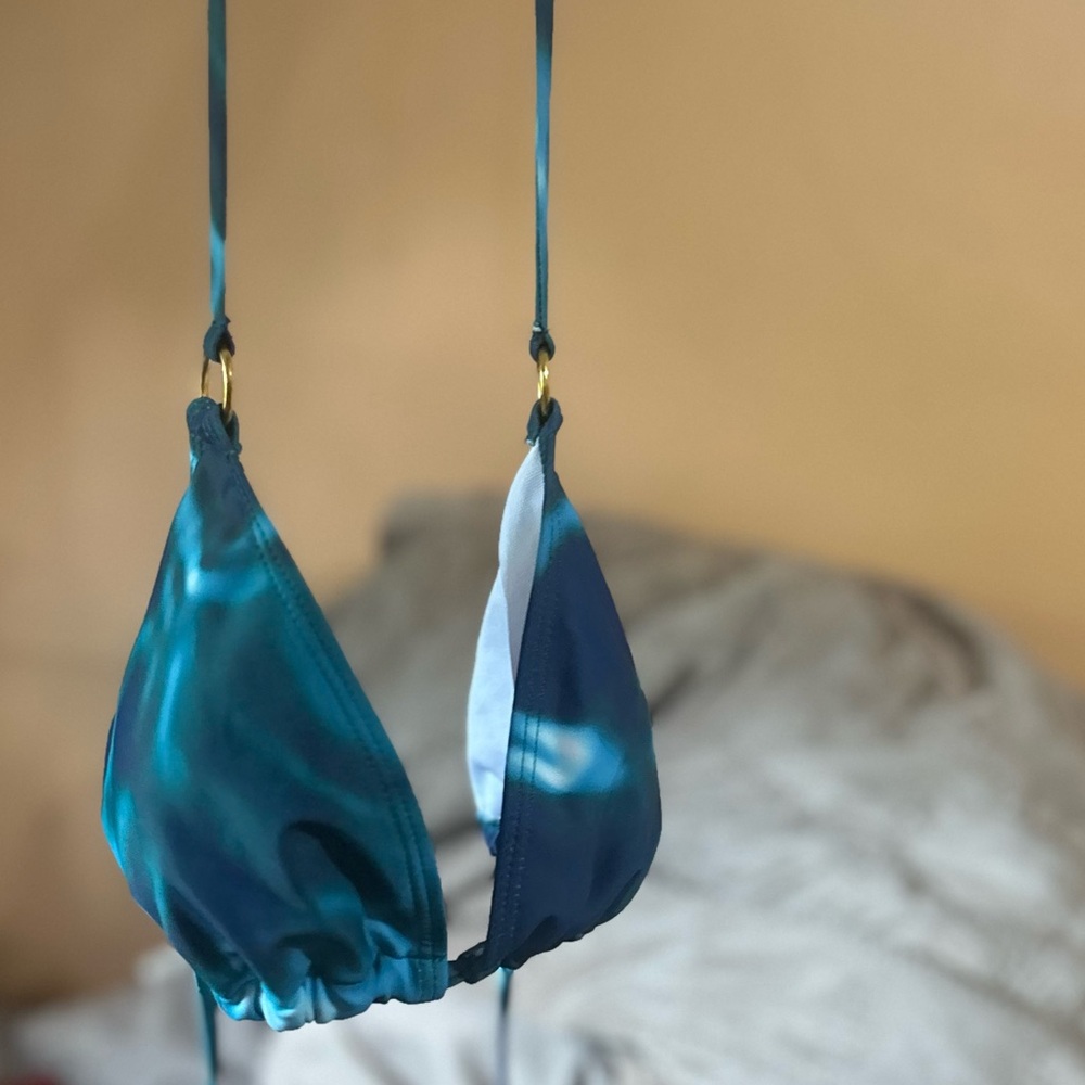 Aqua coloured see through cover up comes with the top. Gold trims